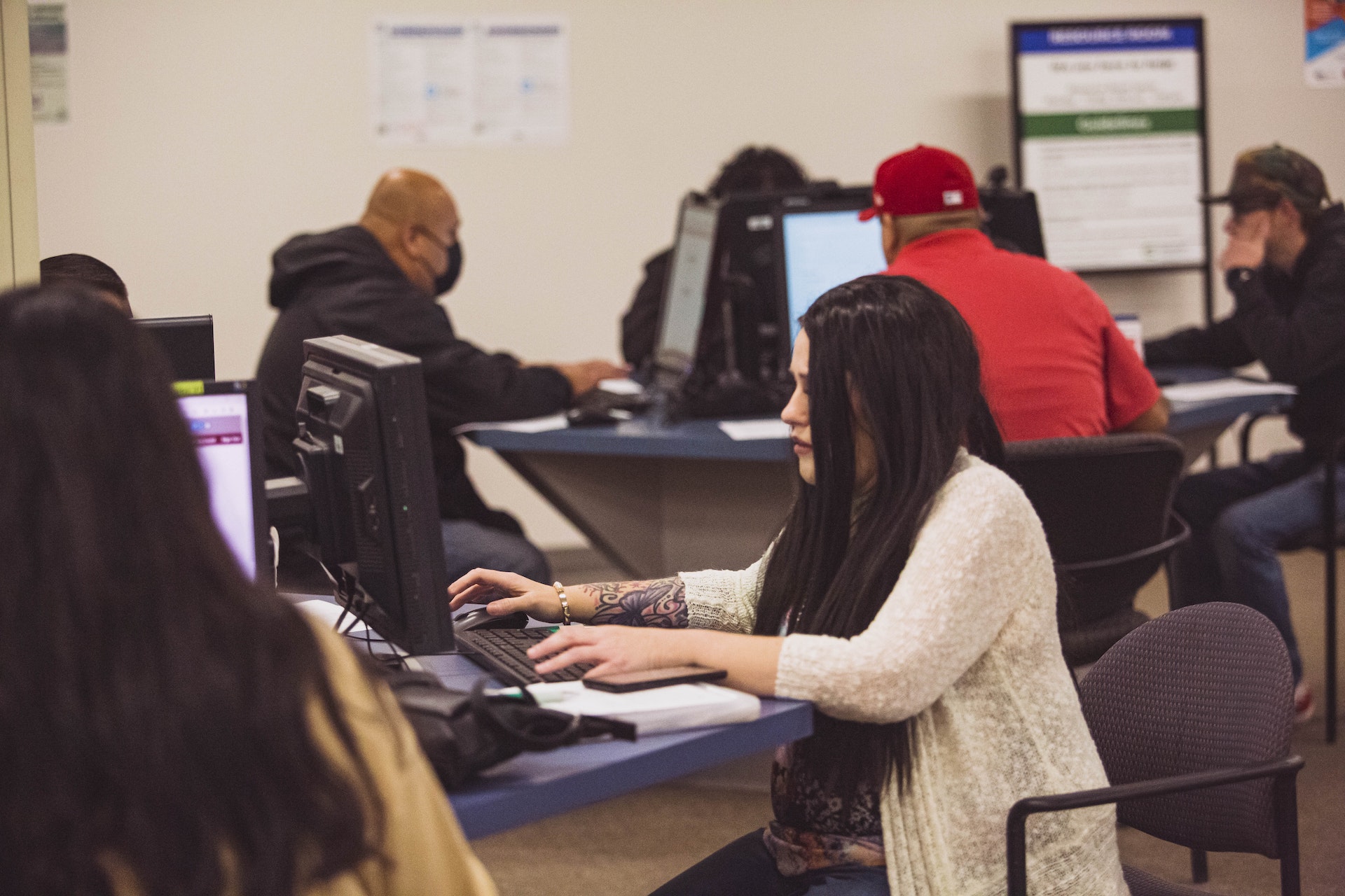 A female job seeker using a computer in the resource room to complete a job application