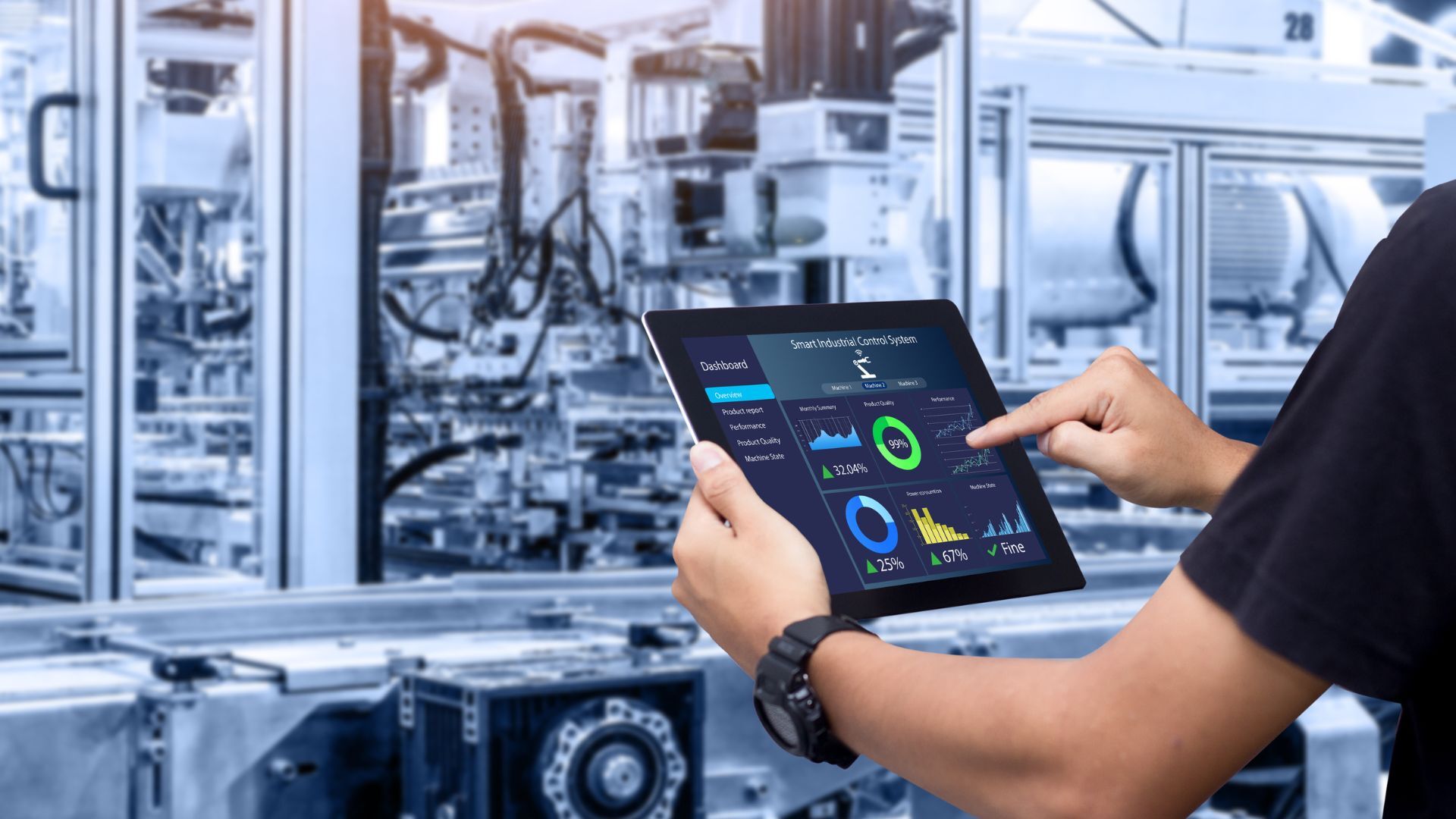 holding a laptop with data in front on machinery